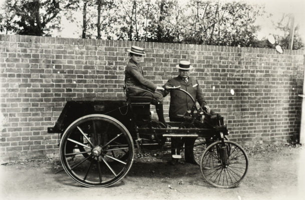 Man and boy with old fashioned car.