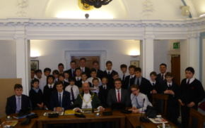 Group of schoolboys in Farnham council chamber with the Mayor of Farnham.