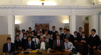 Group of schoolboys in Farnham council chamber with the Mayor of Farnham.