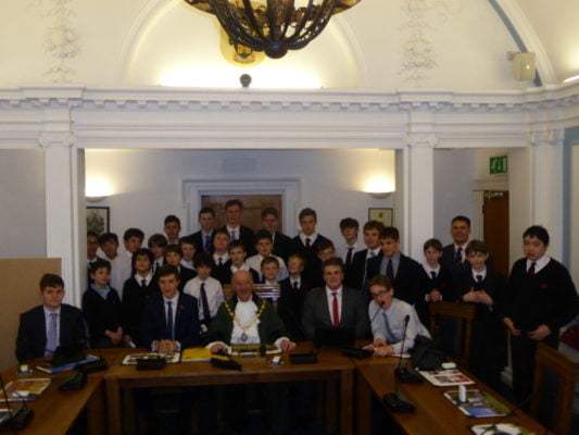 Group of schoolboys in Farnham council chamber with the Mayor of Farnham.