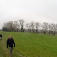 People in field with trees in background. Winter scene