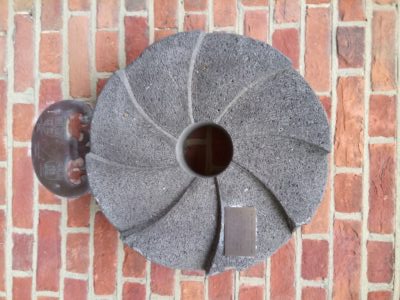 Mill stone on a wall