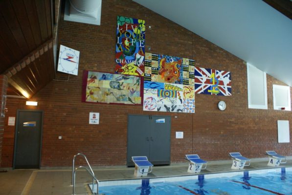 Colourful mural on wall at end of swimming pool.