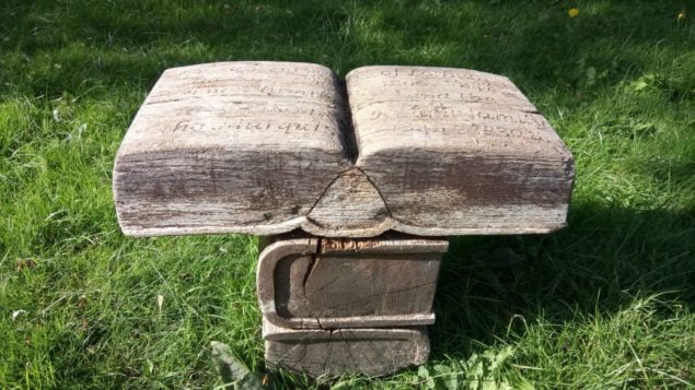 Wooden carving of an open book
