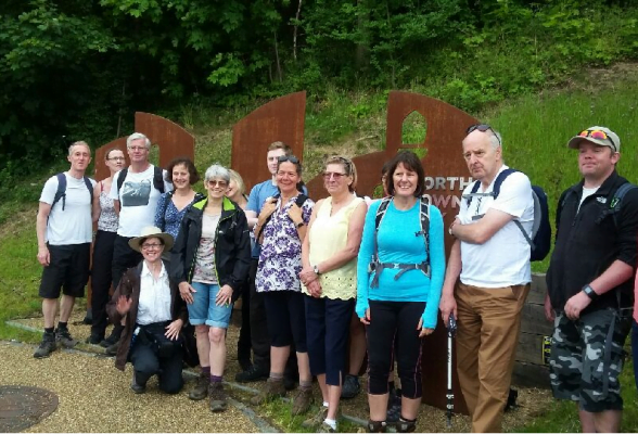 Group of people in front of a sculpture