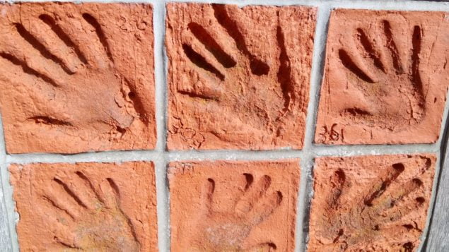 Hand prints in brick tiles
