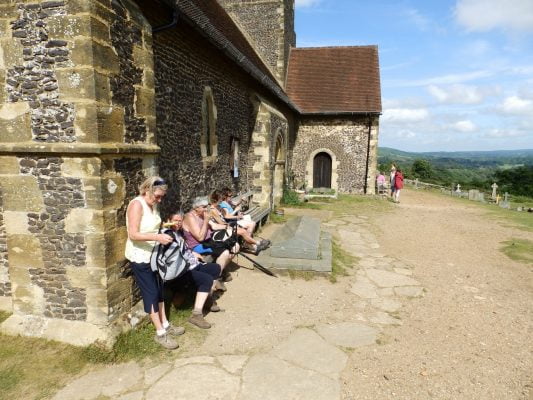 People sitting outside a chapel