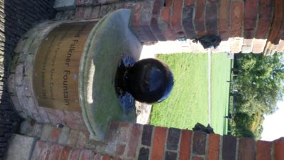 Commemorative brick built water fountain with brick arch over.