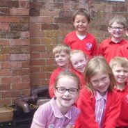 School children by a gate.