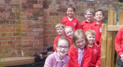 School children by a gate.