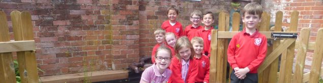 School children by a gate.