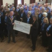 Group of people and the Mayor holding a large cheque.