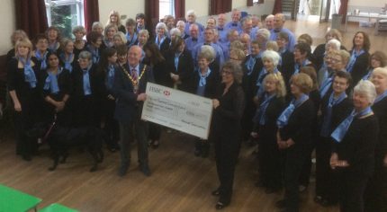 Group of people and the Mayor holding a large cheque.