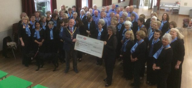 Group of people and the Mayor holding a large cheque.