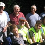 Group of people sitting in a garden.