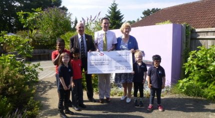 John Ward presents large cheque to the Ridgeway School