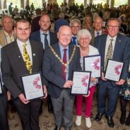 Group of people holding certificates.