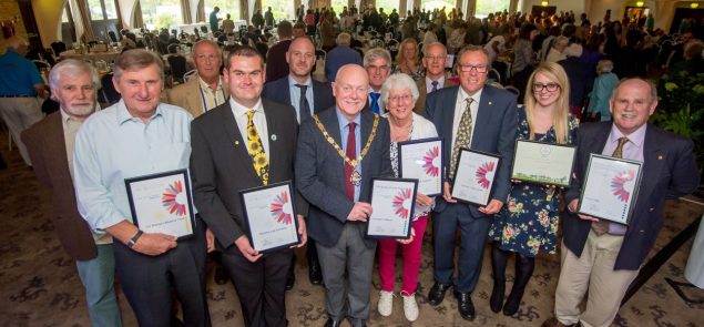 Group of people holding certificates.