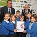 Group o children holding a certificate.