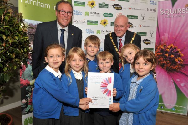 Group o children holding a certificate.