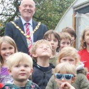 Children and Mayor outside poly tunnel