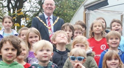 Children and Mayor outside poly tunnel