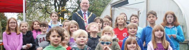 Children and Mayor outside poly tunnel