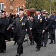 People marching in a remembrance parade.