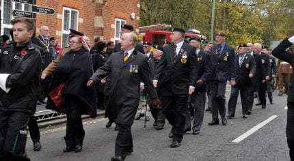 People marching in a remembrance parade.