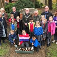 Schoolchildren with Dutch flag and container of tulip bulbs