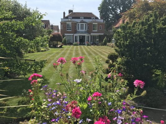Formal garden with shrubs and flowers around edge