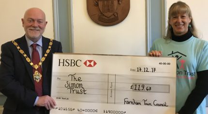 Mayor presents large cheque to a female representing The Simon Trust charity.
