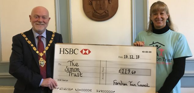 Mayor presents large cheque to a female representing The Simon Trust charity.