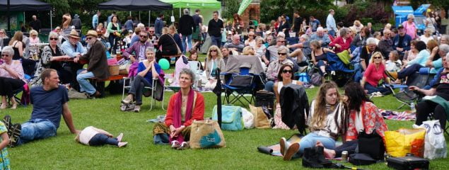 Group of people stitting on the grass.