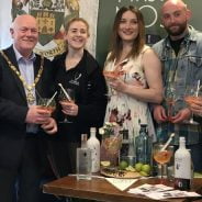 Group of people holding gin glasses.