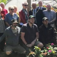 People standing outside a poly tunnel.