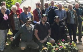 People standing outside a poly tunnel.