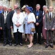 Group of people in smart clothing outside a church.