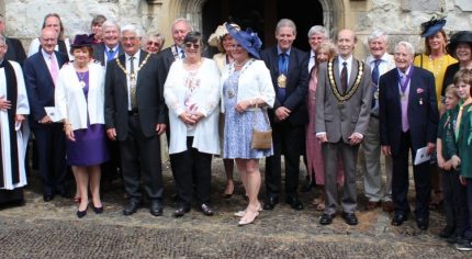 Group of people in smart clothing outside a church.