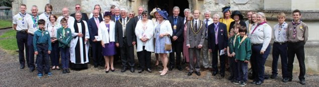 Group of people in smart clothing outside a church.