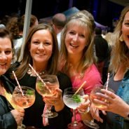 Four females holding gin glasses.