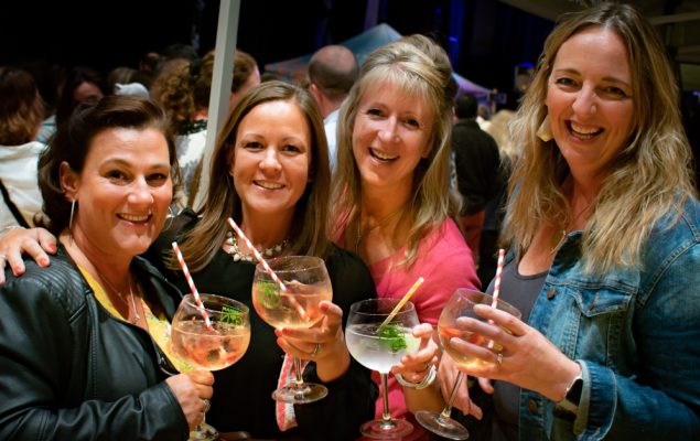 Four females holding gin glasses.