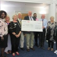 Group of people with a large cheque