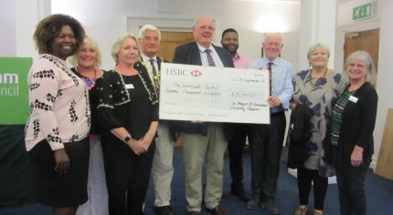 Group of people with a large cheque