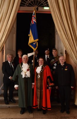 Mayor and group of people in a doorway.