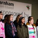 Children singing on stage.