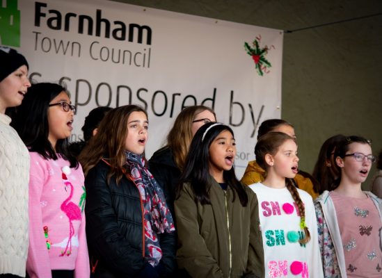 Children singing on stage.