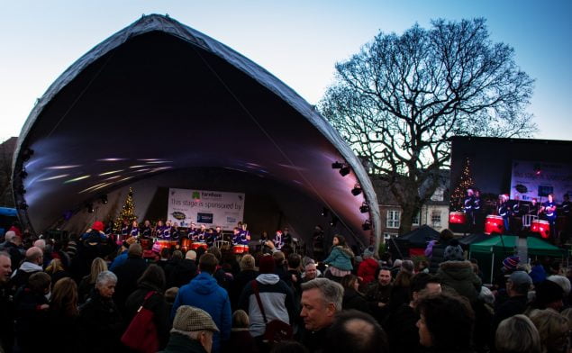 Crowd of people watching drummers perform on stage