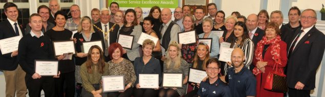 Group of people holding certificates.