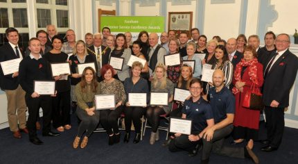 Group of people holding certificates.